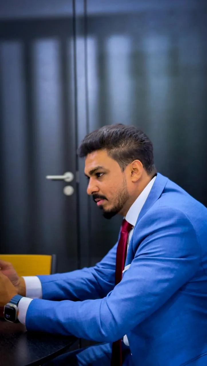 Rashin Hassan, entrepreneur and manufacturing strategist, in a tailored blue suit