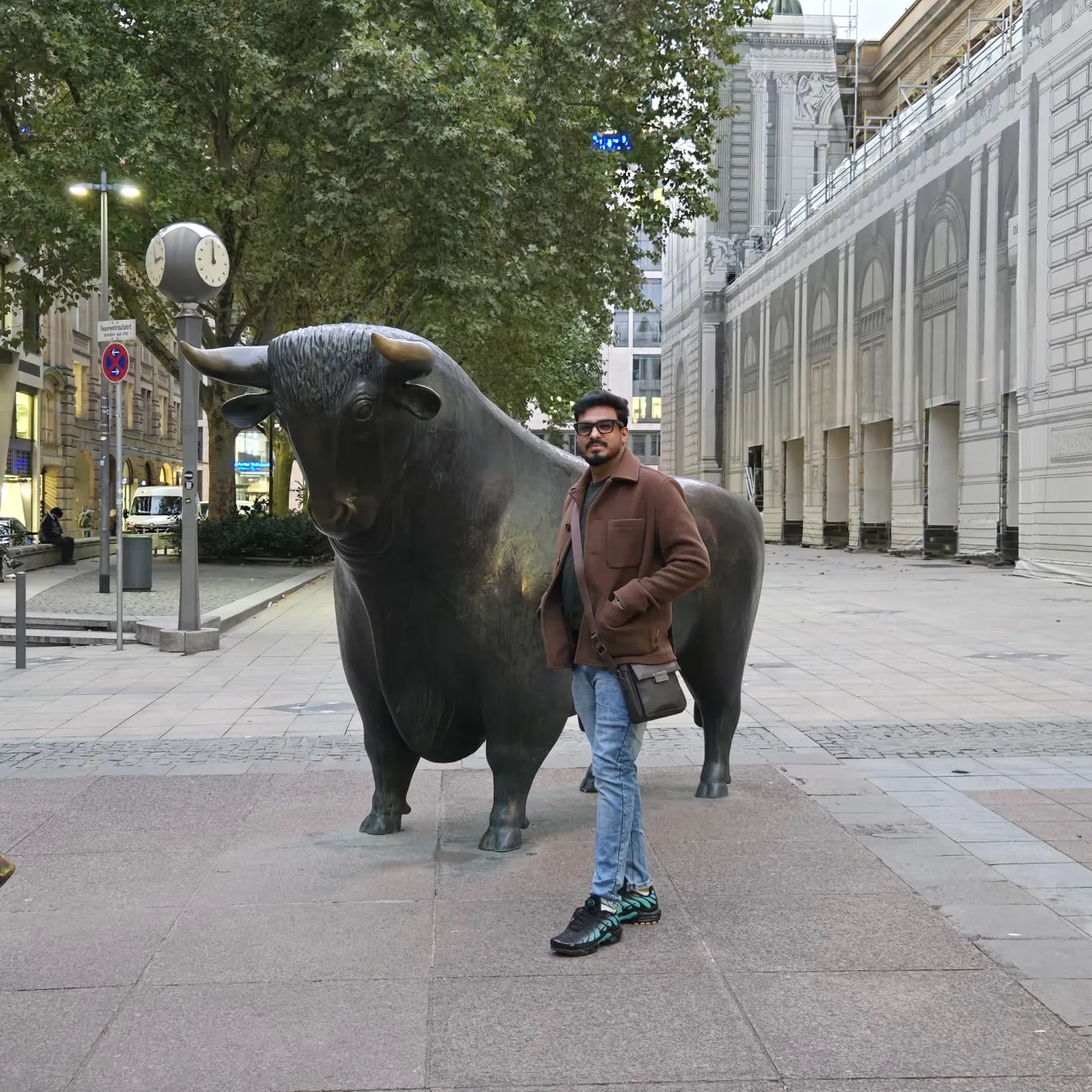 Rashin Hassan beside a bull statue, a nod to markets and business growth